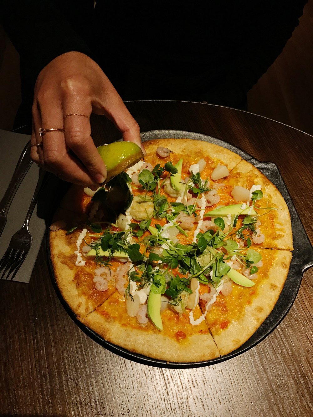 Pictured: Shellfish Pizza (Marinated shellfish, avocado, and herb salad)